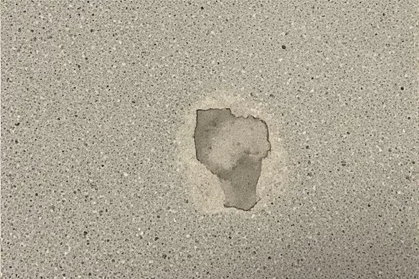 Failed concrete sealer showing peeling and blistering from improper application or moisture